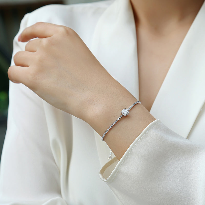 Silver bracelet on a person's wrist with a blurred background Moissanite authentic