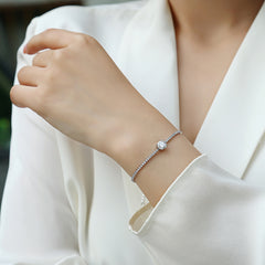 Silver bracelet on a person's wrist with a blurred background Moissanite authentic