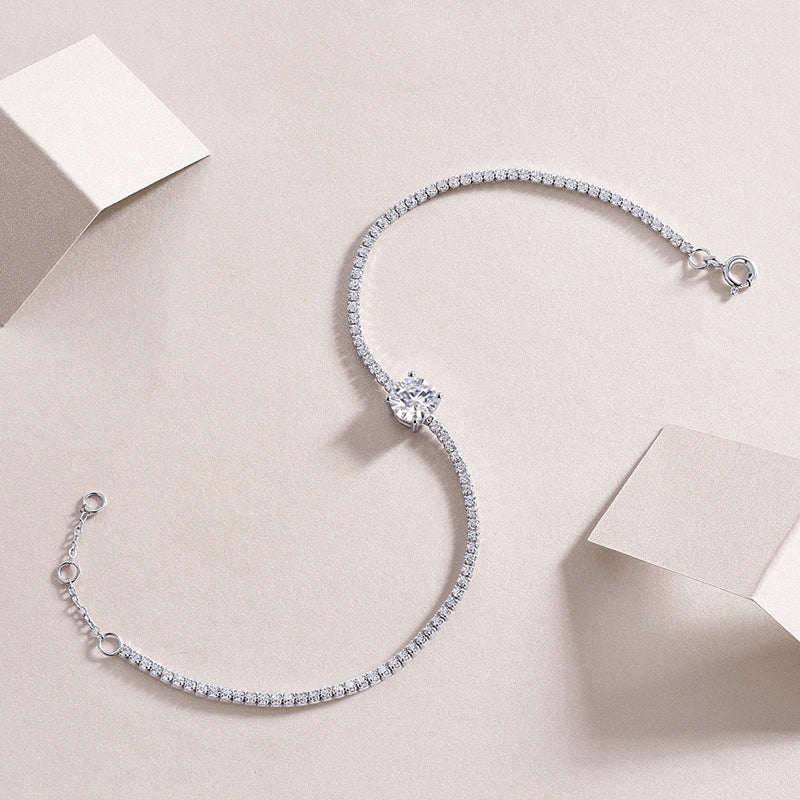 Silver bracelet with clear stones on a light beige background