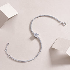 Silver bracelet with clear stones on a light beige background