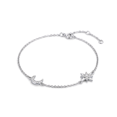 A delicate silver chain bracelet featuring a crescent moon and a starburst charm, both adorned with small clear crystals, displayed on a clean white background.