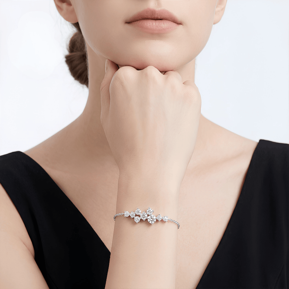 Woman wearing a delicate bracelet on a plain background