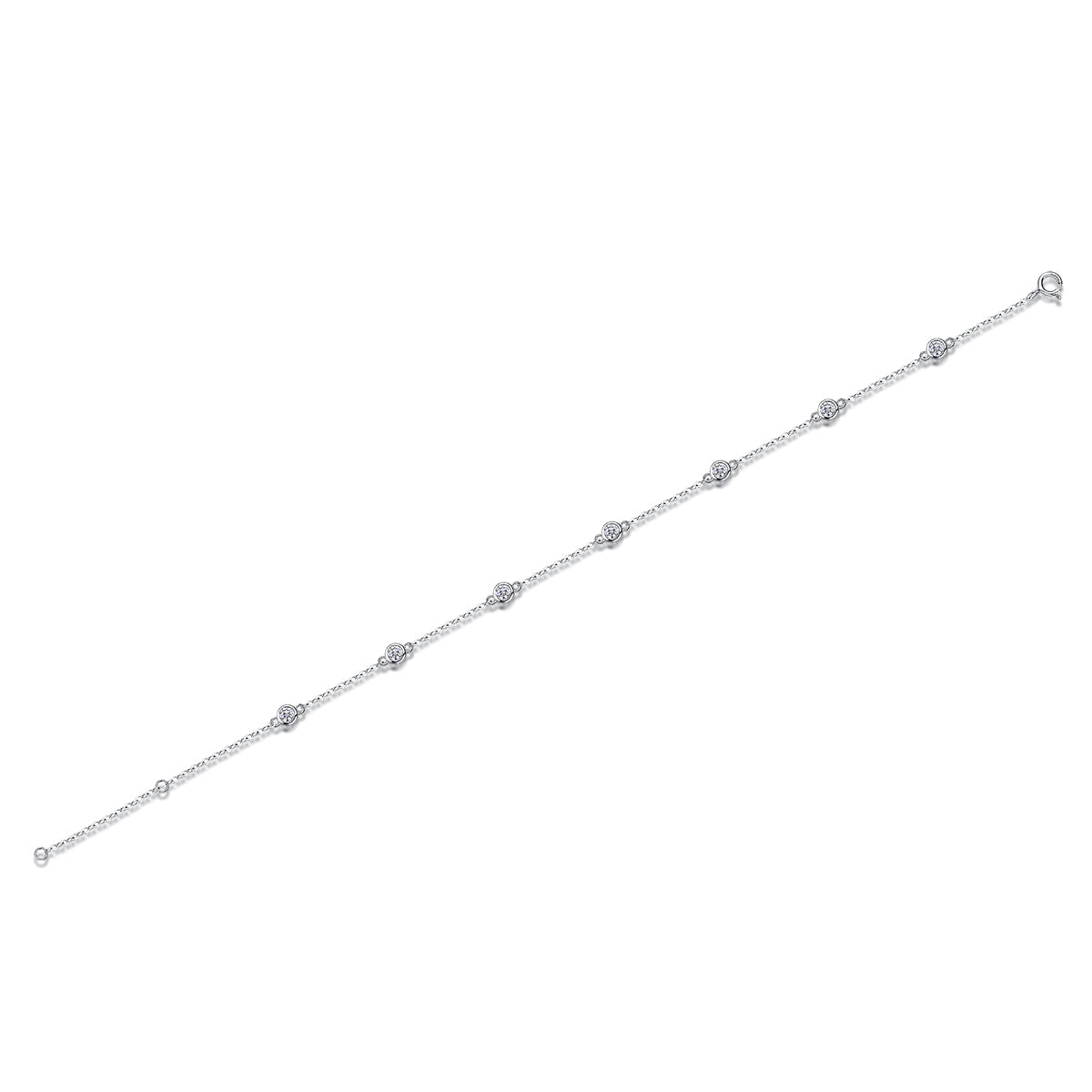 A delicate silver chain bracelet featuring seven evenly spaced round bezel-set clear stones, displayed diagonally on a solid white background.