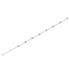 A delicate silver chain bracelet featuring seven evenly spaced round bezel-set clear stones, displayed diagonally on a solid white background.