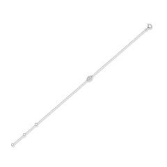 A delicate silver chain bracelet with a small central floral cluster and three small round beads along one side, shown on a plain white background.