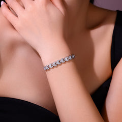 Silver bracelet on a person's wrist with a blurred background