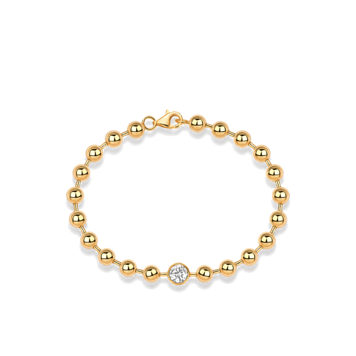 A gold beaded bracelet with a single round clear gemstone accent, displayed on a clean white background.