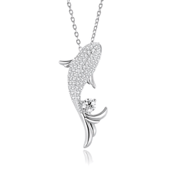 A silver-toned fish pendant necklace paved with small clear stones, with a single round clear gemstone near the tail, shown on a white background with a faint reflection below.