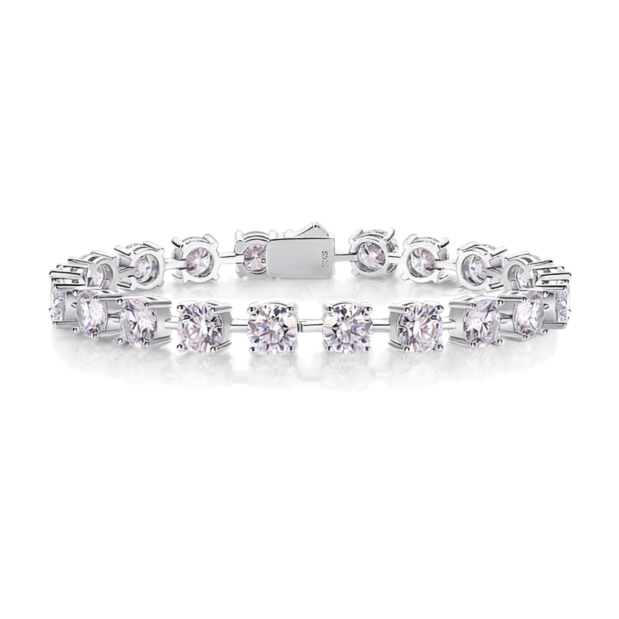 A silver tennis bracelet featuring round-cut clear gemstones in a prong setting, displayed on a clean white background.