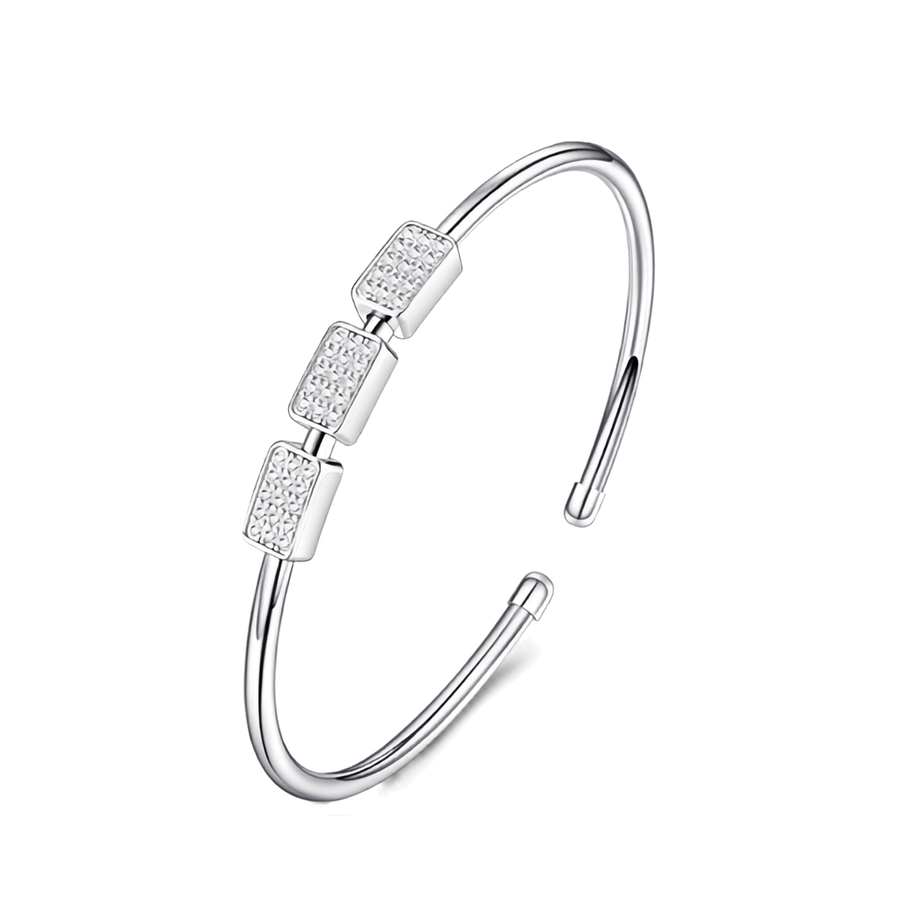 A silver-toned open cuff bangle bracelet with three rectangular bezel-set clear stones on the front, shown on a plain white background.