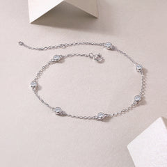 Silver bracelet with gemstones on a light beige background