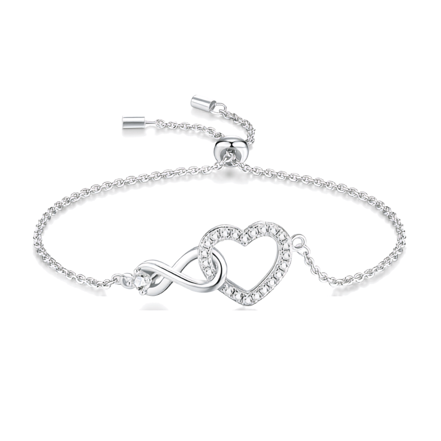 A silver adjustable adjustable bracelet featuring an infinity symbol and a heart-shaped crystal charm, displayed on a clean white background.