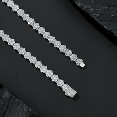 Silver bracelet with clear stones on a dark surface