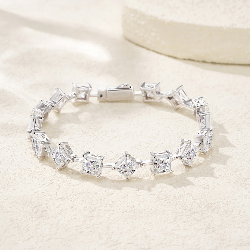 Silver bracelet with clear gemstones on a light beige background