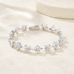 Silver bracelet with clear gemstones on a light beige background