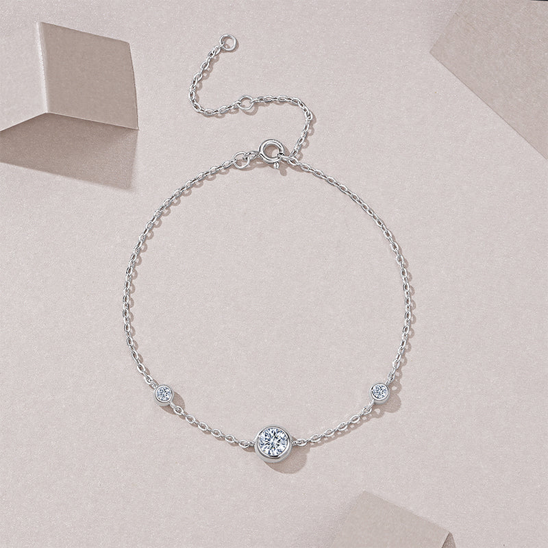 Silver bracelet with small crystals on a light pink background