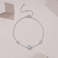 Silver bracelet with small crystals on a light pink background