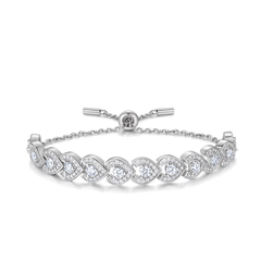 A silver tennis bracelet featuring heart-shaped pavé settings with clear round and pear-cut gemstones, shown on a clean white background.