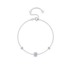 A delicate silver chain bracelet with three bezel-set round clear stones, featuring a larger central round stone and two smaller accent stones, displayed on a clean white background.