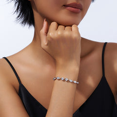 Woman wearing a silver bracelet with a subtle background