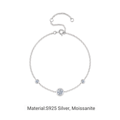 A silver chain bracelet with a central round bezel-set moissanite stone and two smaller side stones, shown on a plain white background with text below reading 'Material:S925 Silver, Moissanite'.