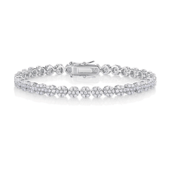 A silver tennis bracelet featuring a double row of round-cut diamonds in a pave setting, with a polished clasp closure, displayed on a clean white background.