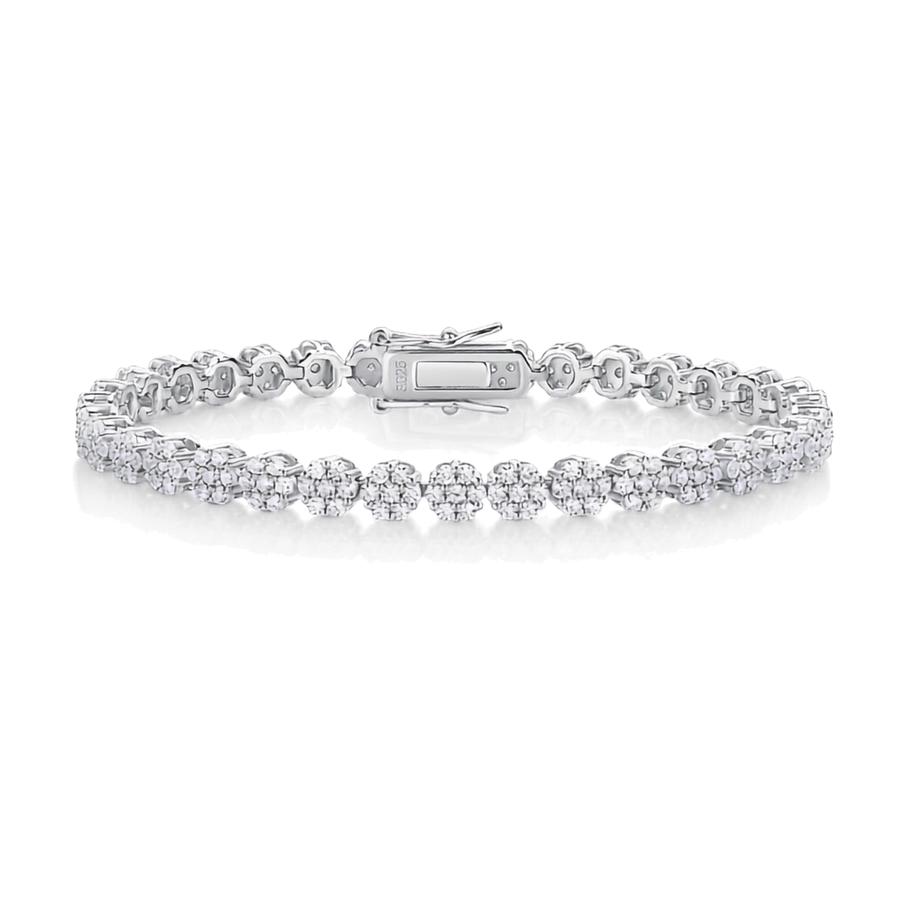 A silver tennis bracelet featuring a double row of round-cut diamonds in a pave setting, with a polished clasp closure, displayed on a clean white background.