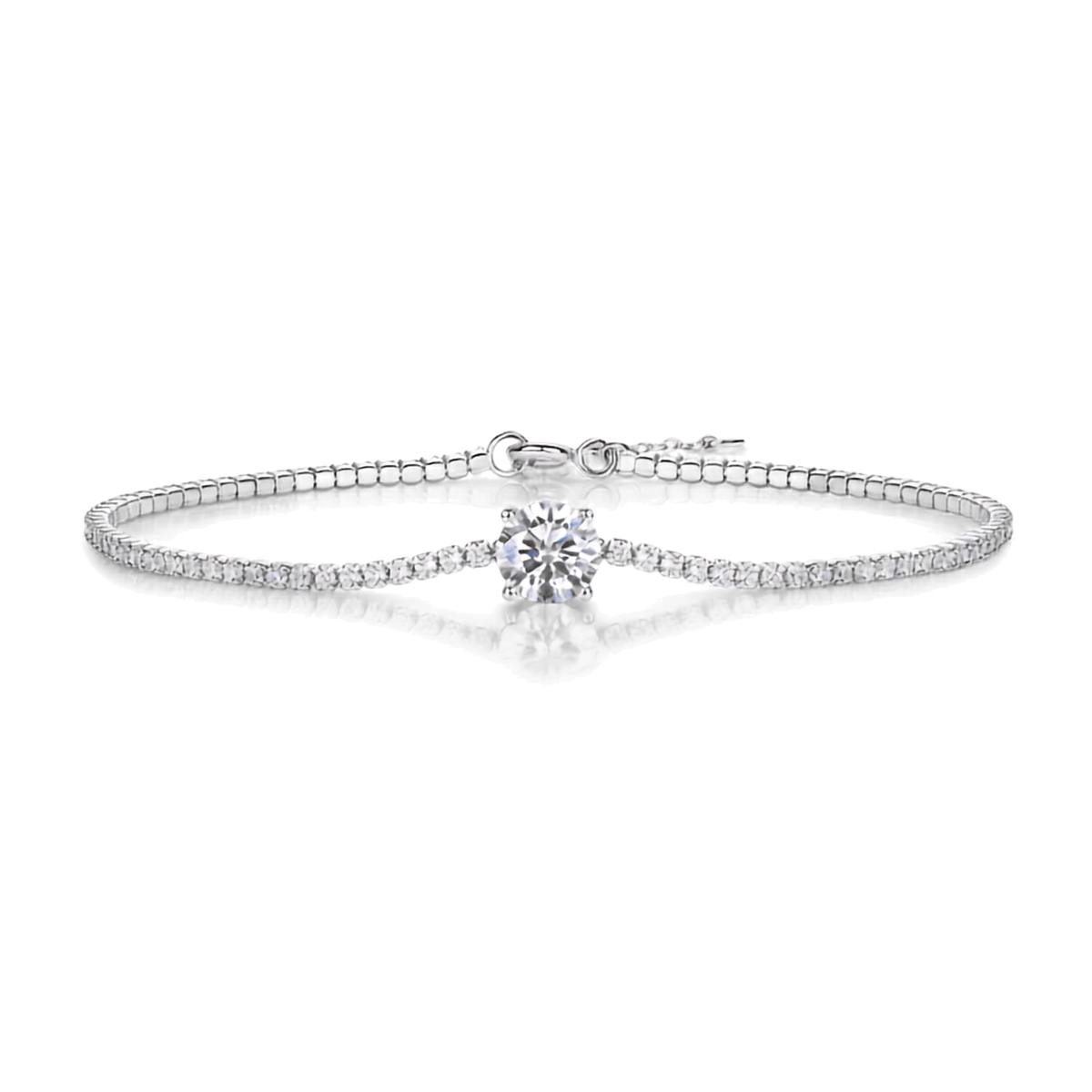 A silver-toned tennis bracelet featuring a central round-cut clear gemstone and a row of small pavé-set stones along the band, shown on a clean white background with a soft reflection.
