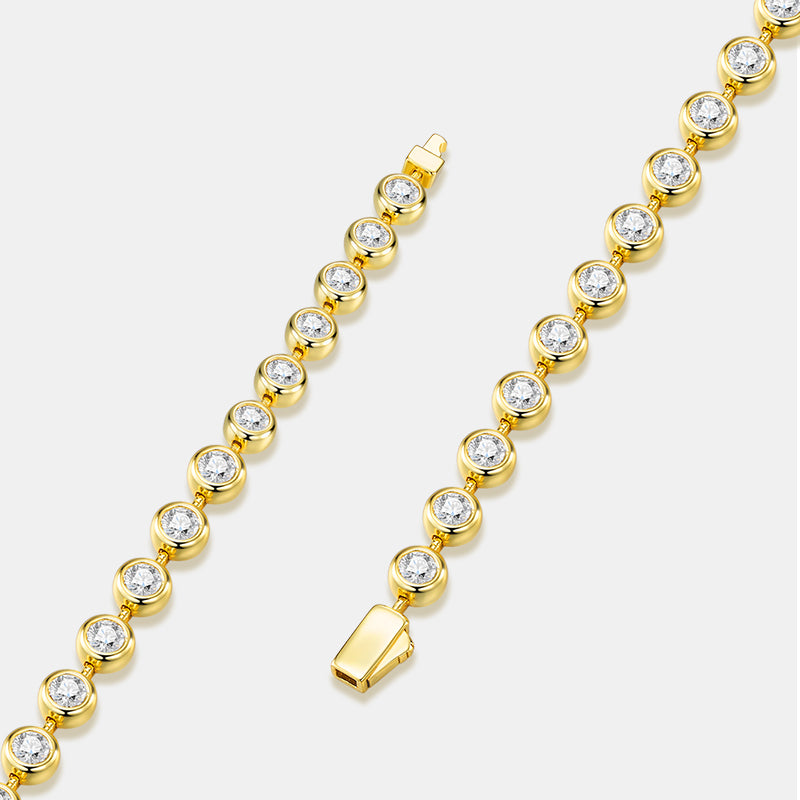 A gold tennis-style bracelet with round clear gemstones in bezel settings, shown on a light gray background with two close product views.