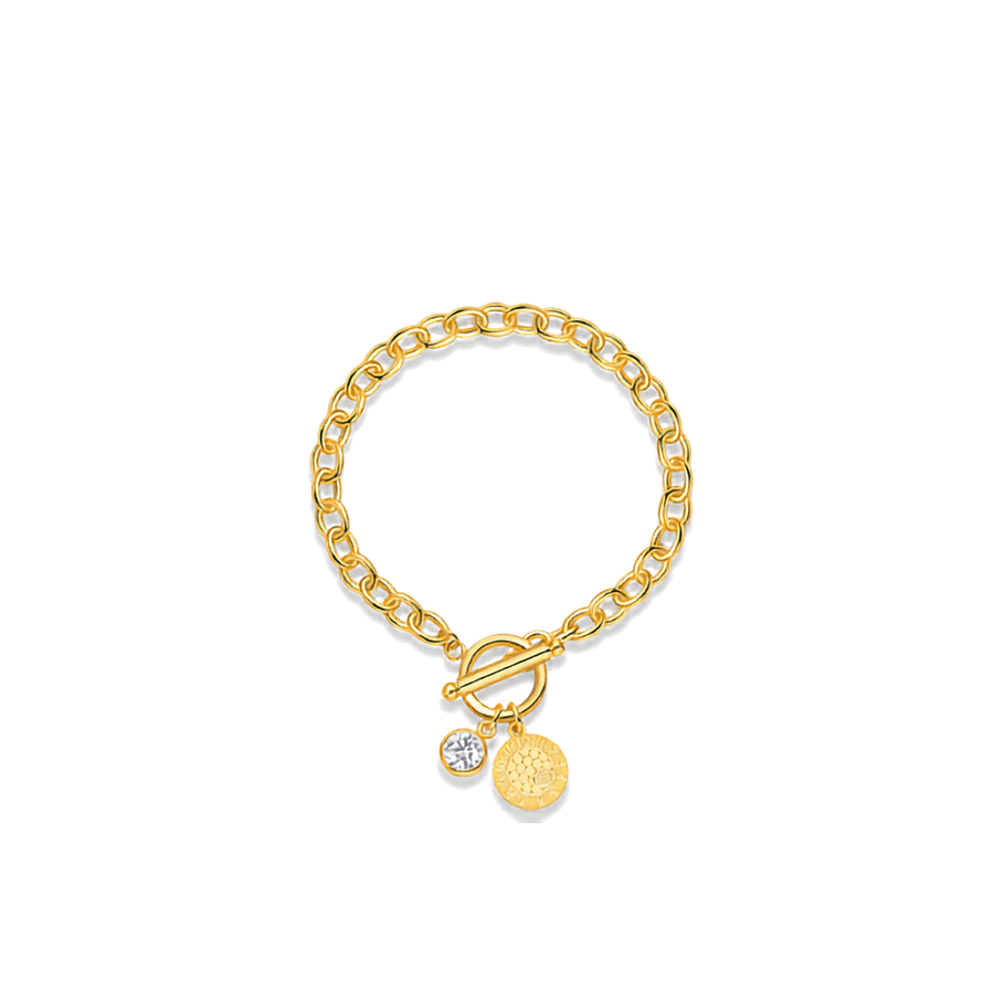 A gold chain bracelet with a toggle clasp, featuring two hanging charms: a small clear round stone and a textured gold disc, displayed on a clean white background.